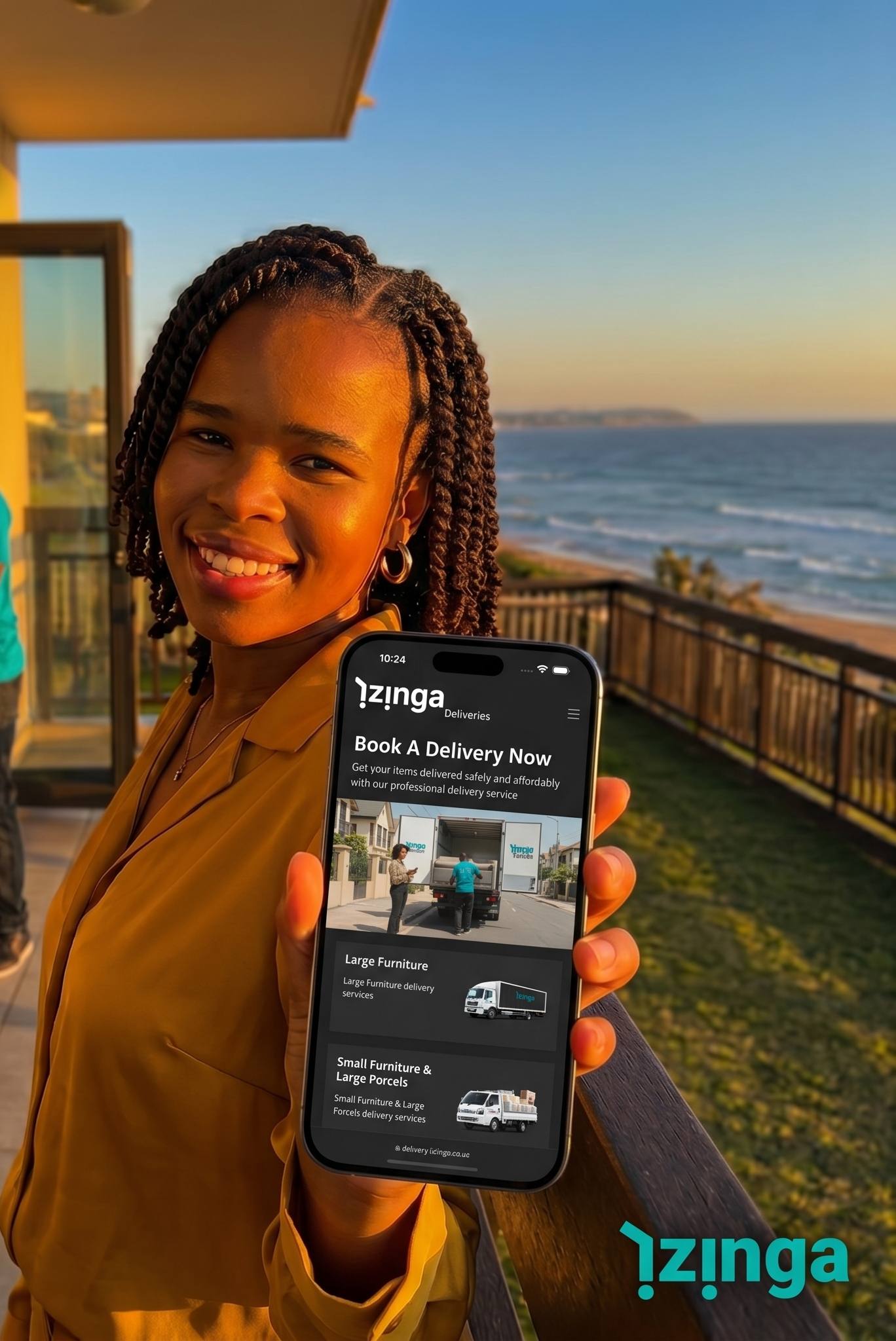 Customer smiling on a coastal balcony holding a phone showing the iZinga delivery booking screen, with iZinga drivers moving branded boxes in the background